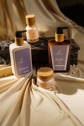 Luxury skincare essentials on silky fabric for elegant presentation.